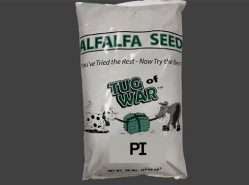 Bag of alfalfa seed labeled "Tug of War," featuring cartoon animals and text promoting quality